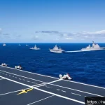 Home 21 해군 국제 협력 및 동맹 관계 - A detailed scene of a multinational naval exercise in the Pacific Ocean, featuring diverse naval shi...